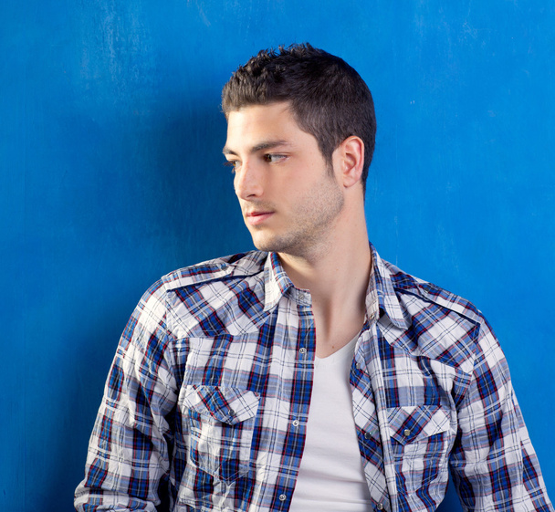 Handsome young man with plaid shirt on blue - Fotoğraf, Görsel