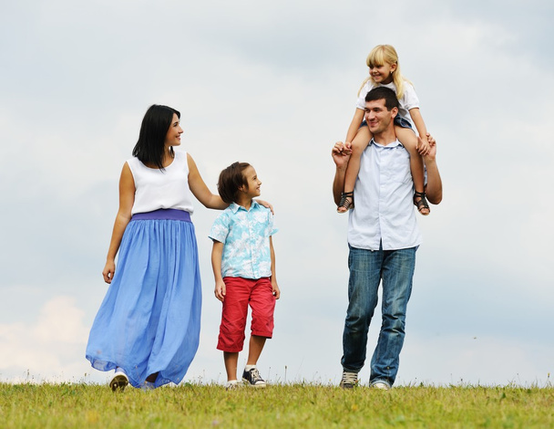 Happy family in nature walking on green summer meadow - Fotografie, Obrázek