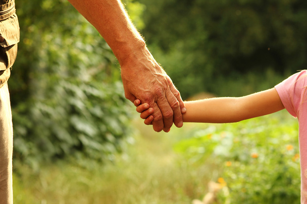 Parent holds hand of child - Fotó, kép
