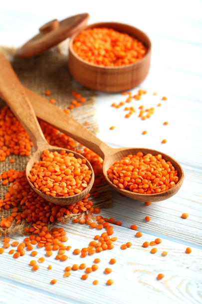 Red lentils in the wooden spoons - Foto, Imagen
