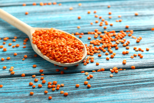 Red lentils in the wooden spoon - Фото, зображення