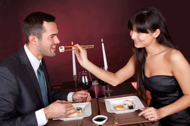 Young couple eating sushi in restaurant - Fotografie, Obrázek