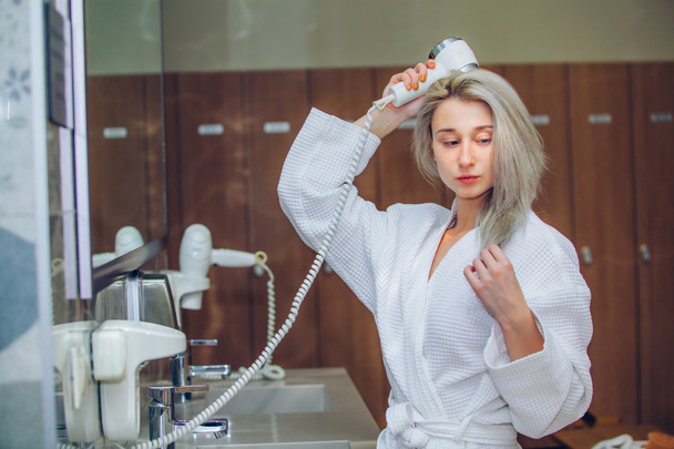 Woman dry hair hairdryer at bathroom. Female with dryer  home - Zdjęcie, obraz