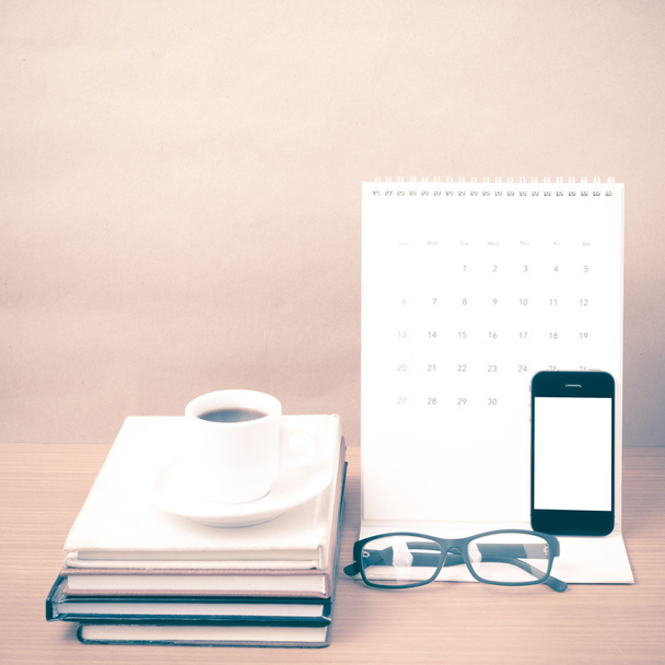 coffee,phone,eyeglasses,stack of book and calendar - Photo, image