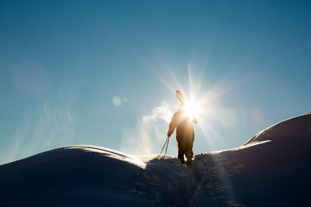 Male in fresh snow on ski slope on a sunny winter day at the ski resort in Georgia - Foto, Imagen