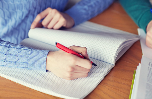 close up of student hands writing to notebook - Φωτογραφία, εικόνα