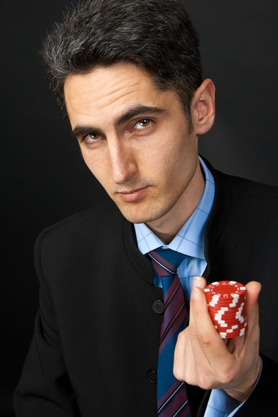 Gambler with chips in hand. - Фото, изображение