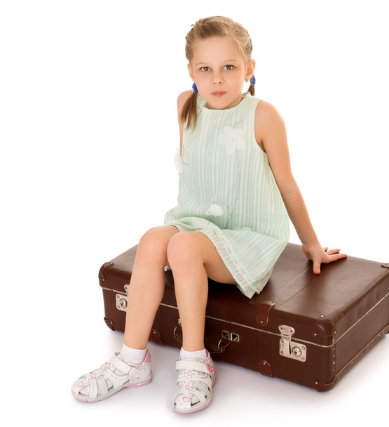 Girl sitting on suitcase - Fotoğraf, Görsel