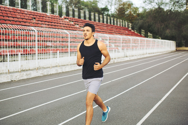 Man running on a racing track - Photo, Image