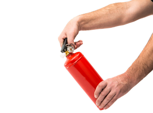 a fire extinguisher in his hands  - Foto, afbeelding