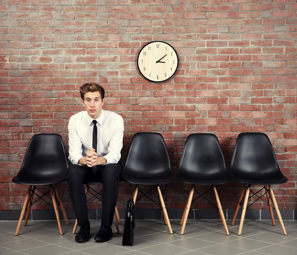 Young businessman sitting on a chair  - Foto, imagen