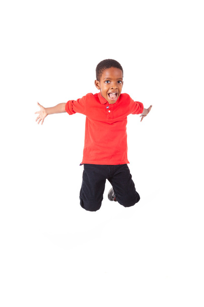 Portrait of a cute african american little boy jumping, isolated - Foto, Imagem