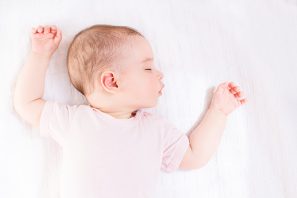 So cute baby girl sleeping on white bed - Foto, immagini