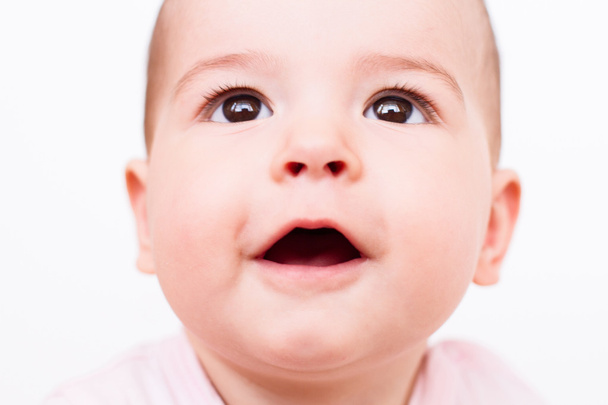 Surprised beautiful baby look up on white - Foto, Imagen