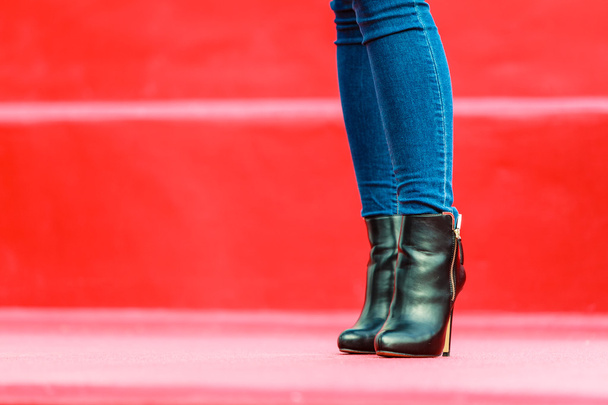 woman legs in denim pants heels boots outdoor - Фото, зображення