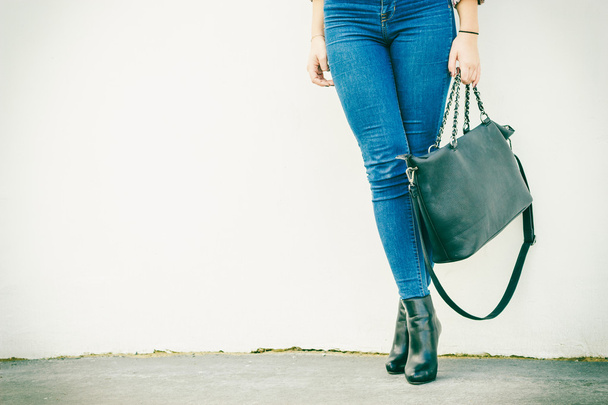 woman legs in heels shoes handbag in hand - 写真・画像