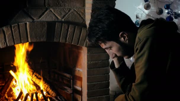 guy thinking in front of a fireplace - Footage, Video