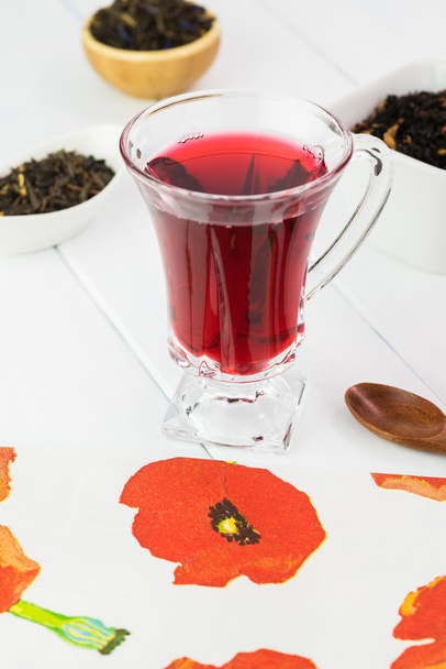 Glass tea cup with red hibiscus tea. - Фото, изображение