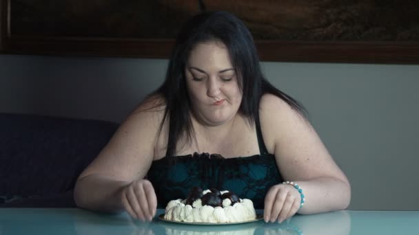 Fat woman eating with voracity a cake: obesity, diet problems, weight problems - Кадры, видео
