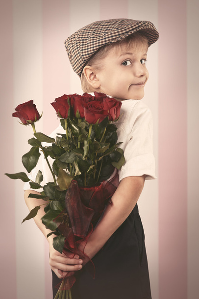Retro boy with bouquet of roses - Photo, Image