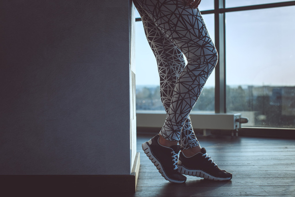 Woman's legs in a grey sport pants. - Photo, Image