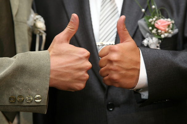 each bride and groom show of hands with thumb up - Photo, Image