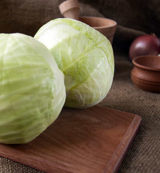 cabbage on a wooden board on a background sacking, burlap  - Foto, imagen