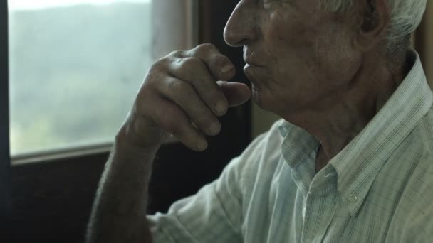 sad old man sitting alone - Filmati, video
