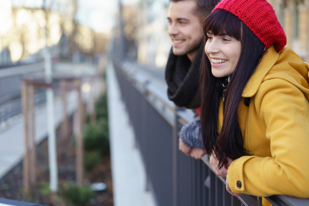 Happy trendy young couple watching something - 写真・画像