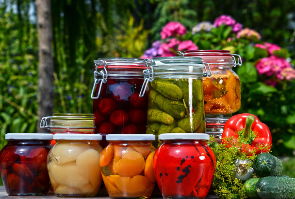 Purkit marinoituja vihanneksia ja hedelmiä puutarhassa
 - Valokuva, kuva