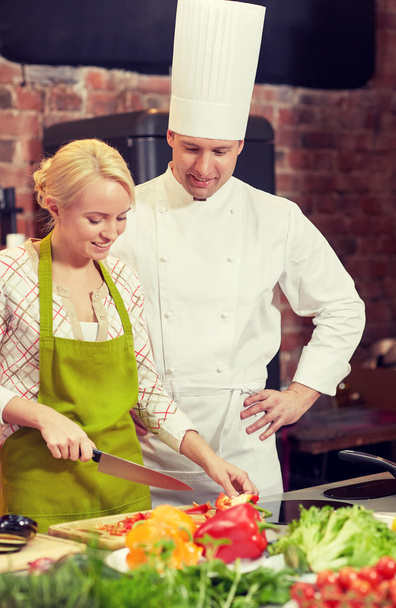 happy male chef cook with woman cooking in kitchen - Valokuva, kuva