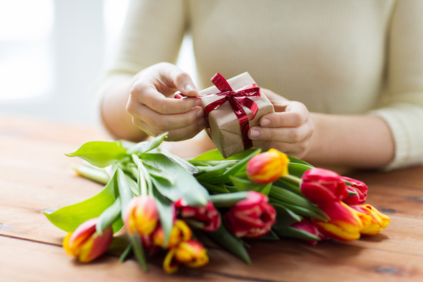 close up of woman with gift box and tulip flowers - Fotoğraf, Görsel