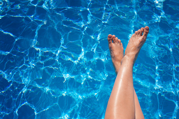woman legs splashing in tropical swimming pool - Photo, Image