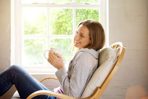 Smiling woman relaxing at home - Photo, Image