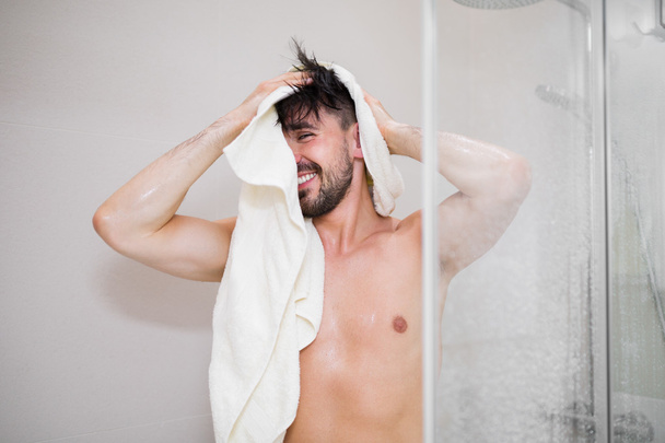Carefree young man after taking shower - Foto, afbeelding