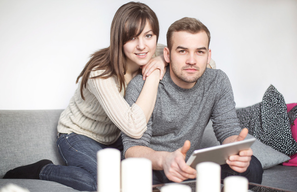 Couple sitting on sofa and surfing the net - Photo, Image