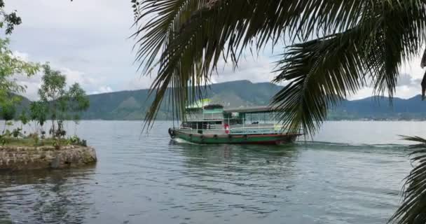 Lake Toba Landscape with Boat and Palm Tree - Video, Çekim