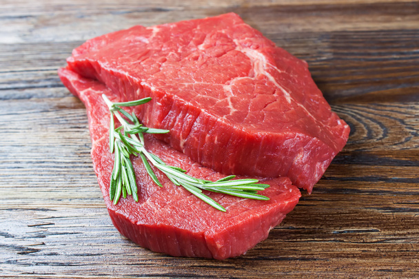 Fresh raw meat with rosemary  - Photo, Image