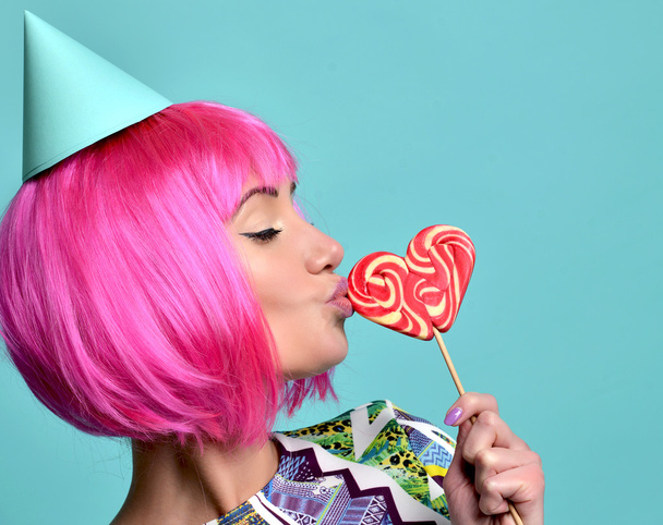 beautiful funny fashion cheerful woman in hot pink party wig eat - Фото, изображение
