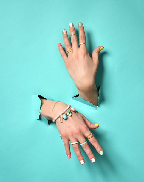 γυναίκα χέρια με κίτρινο ροζ λευκό μοτίβο βερνίκι νυχιών και silve - Φωτογραφία, εικόνα