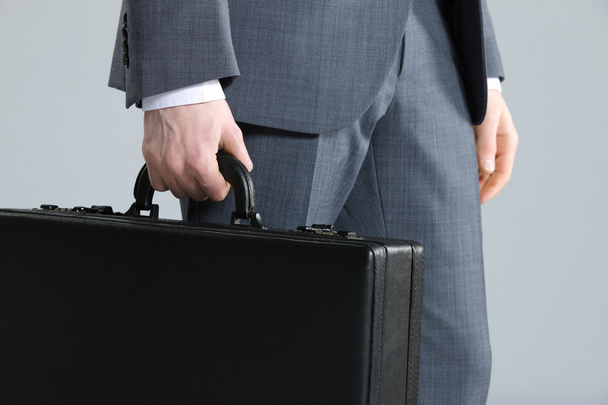 Businessman with suitcase, close up - Foto, Imagen