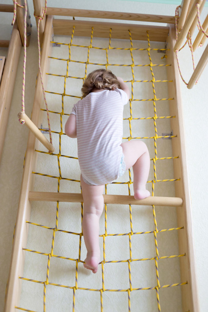 Baby toddler climbing up stairs. - Photo, image