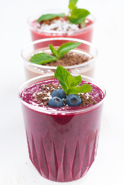 blueberry, chocolate and strawberry milkshakes in glasses - Photo, image