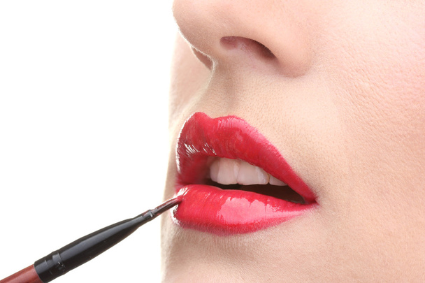 Beautiful woman applying lip gloss - Фото, изображение