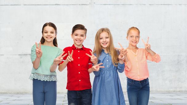 happy boy and girls showing peace hand sign - Zdjęcie, obraz