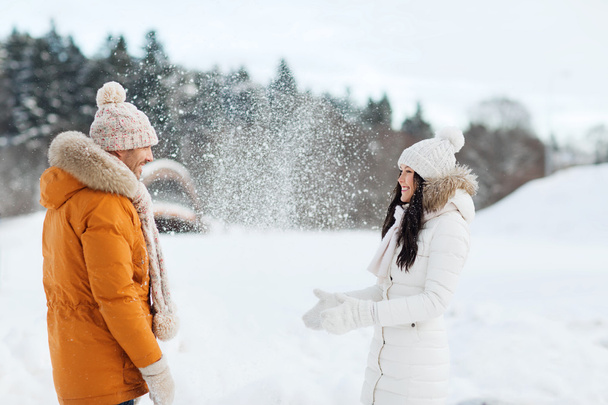 happy couple playing with snow in winter - Zdjęcie, obraz