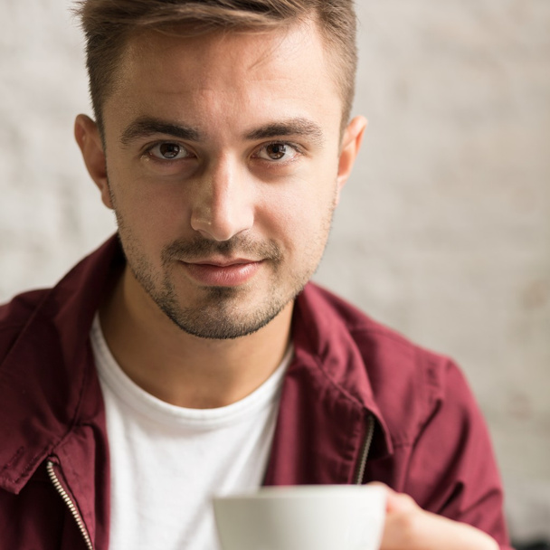 Handsome man with coffee cup - 写真・画像