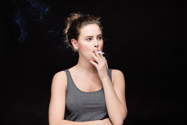 woman smoking concept on black - 写真・画像
