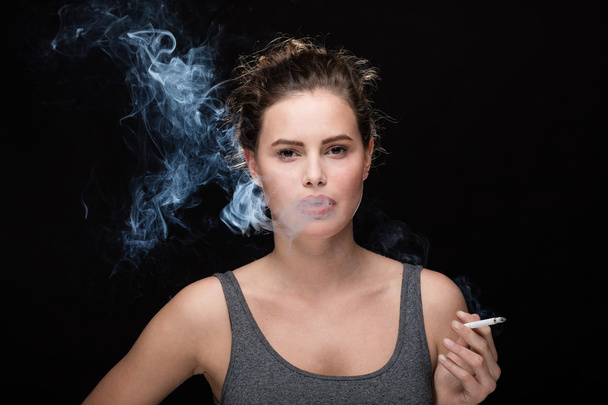 woman smoking concept on black - Foto, imagen