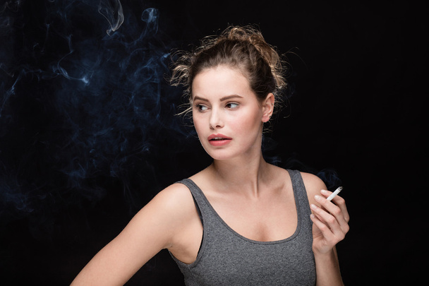 woman smoking concept on black - Fotografie, Obrázek